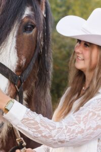 Close-up Montana woman petting brown Clydesdale horse